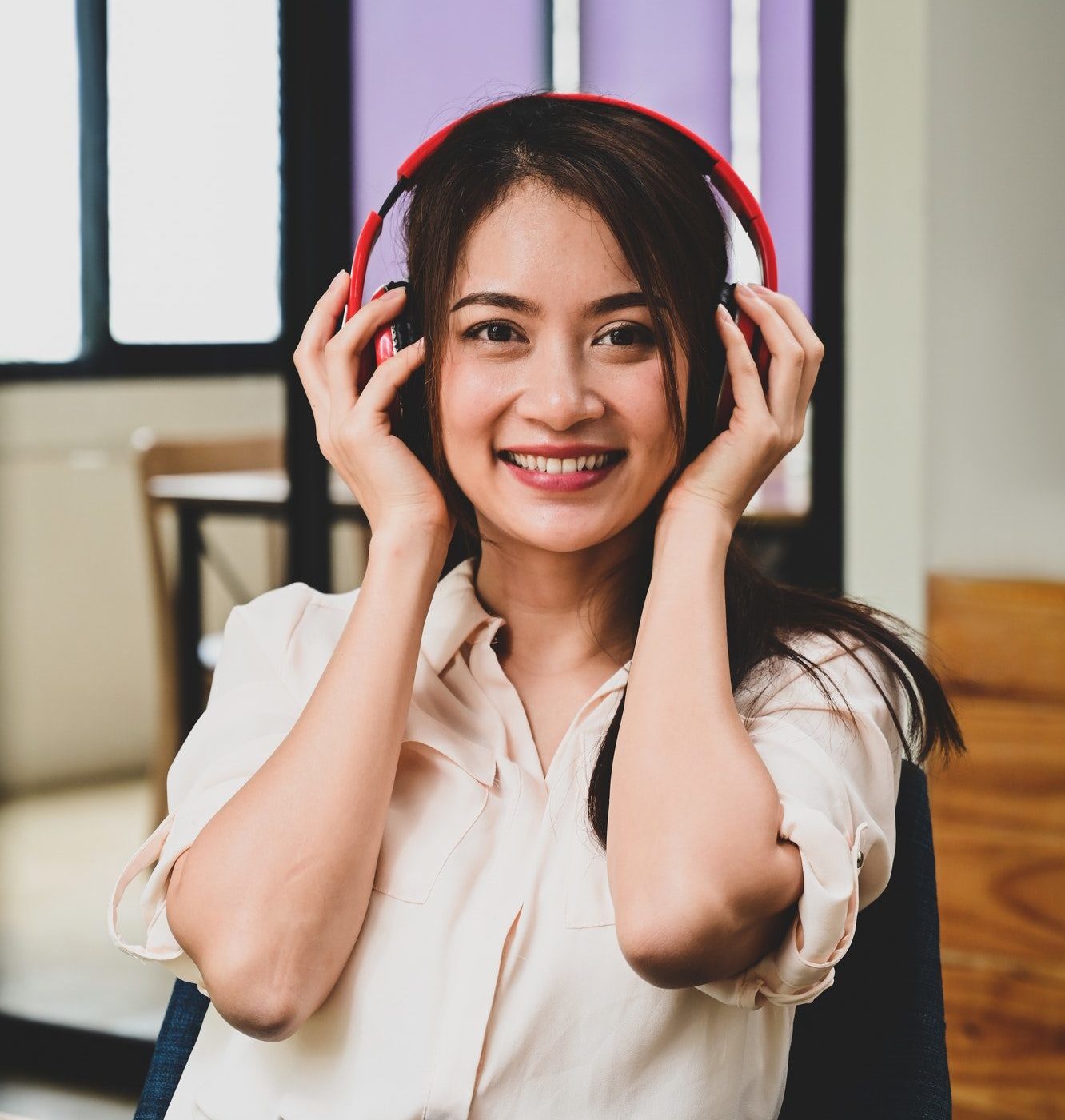 portrait cheerful young woman listening music with headphones e1648539587378